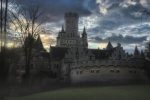Marienburg Castle silhouette under dramatic cloudy sunset