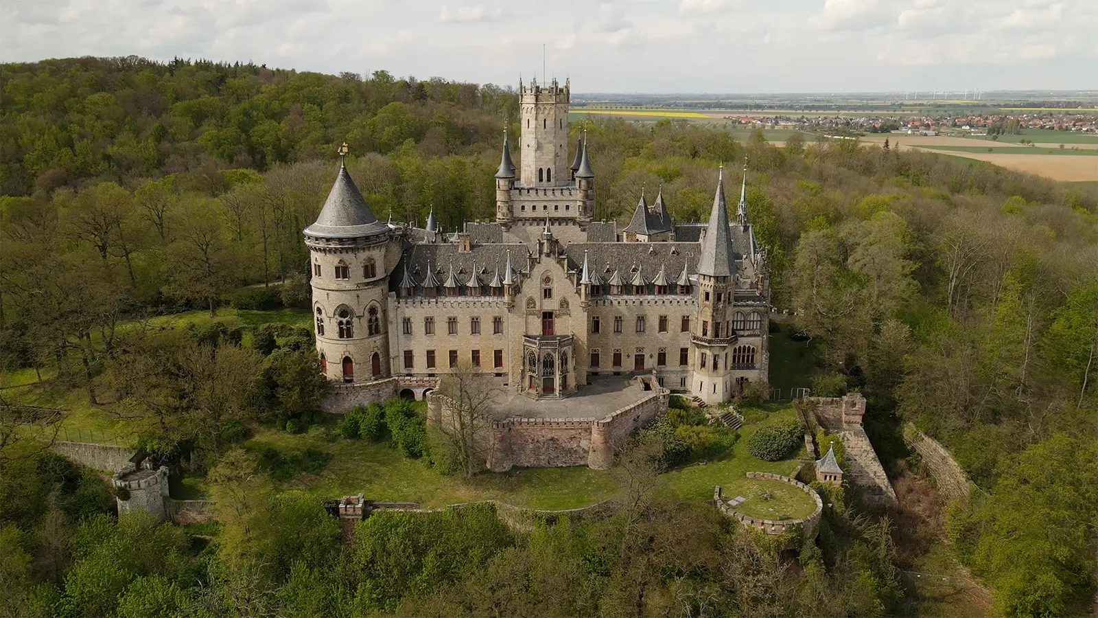 Aerial view of Marienburg Castle surrounded by forest