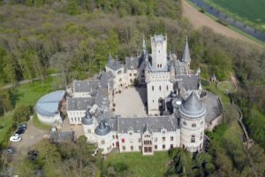 Aerial view of Marienburg Castle surrounded by forest
