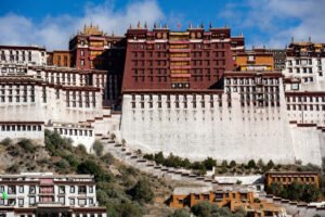 Potala Palace facades on hillside under bright blue sky