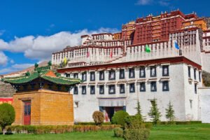 Potala Palace façade and colorful roofs under blue sky