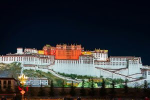 Potala Palace glowing on hillside at night