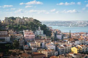São Jorge Castle on hill above colorful Lisbon rooftops and Tagus River