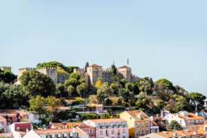 View of São Jorge Castle above colorful Lisbon rooftops