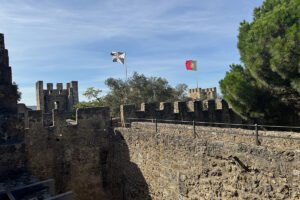 São Jorge Castle stone battlements and Portuguese flag