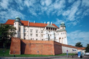Wawel Castle on hill with red roofs and blue sky
