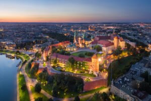 Aerial view of Wawel Castle glowing at twilight