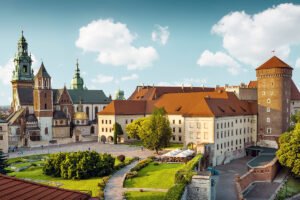 Wawel Castle complex and cathedral towers under blue sky, Kraków