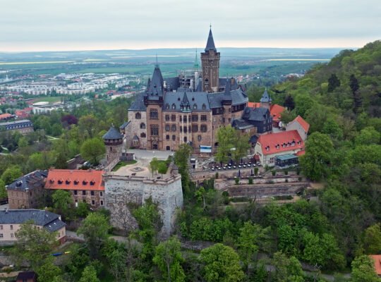 Aerial view of Wernigerode Castle perched above the Harz forests and town
