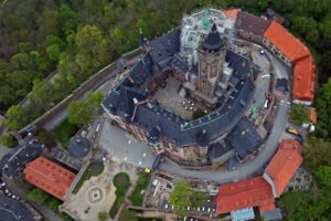 Aerial view of Wernigerode Castle on forested hill