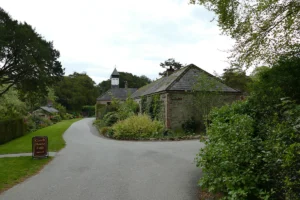 Pathway and stone coach house near Blarney Castle surrounded by gardens