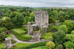 Blarney Castle tower and surrounding green gardens seen from above