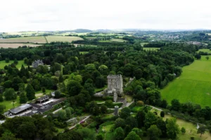 Aerial view of Blarney Castle surrounded by green parkland