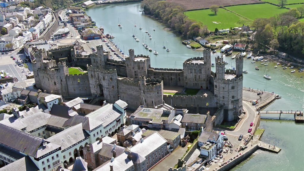 Aerial view of Caernarfon Castle beside the Menai Strait
