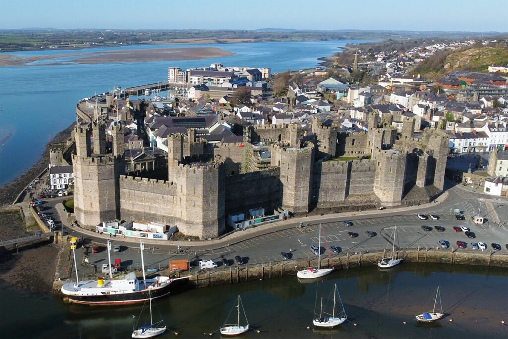 Aerial view of Caernarfon Castle beside the Menai Estuary