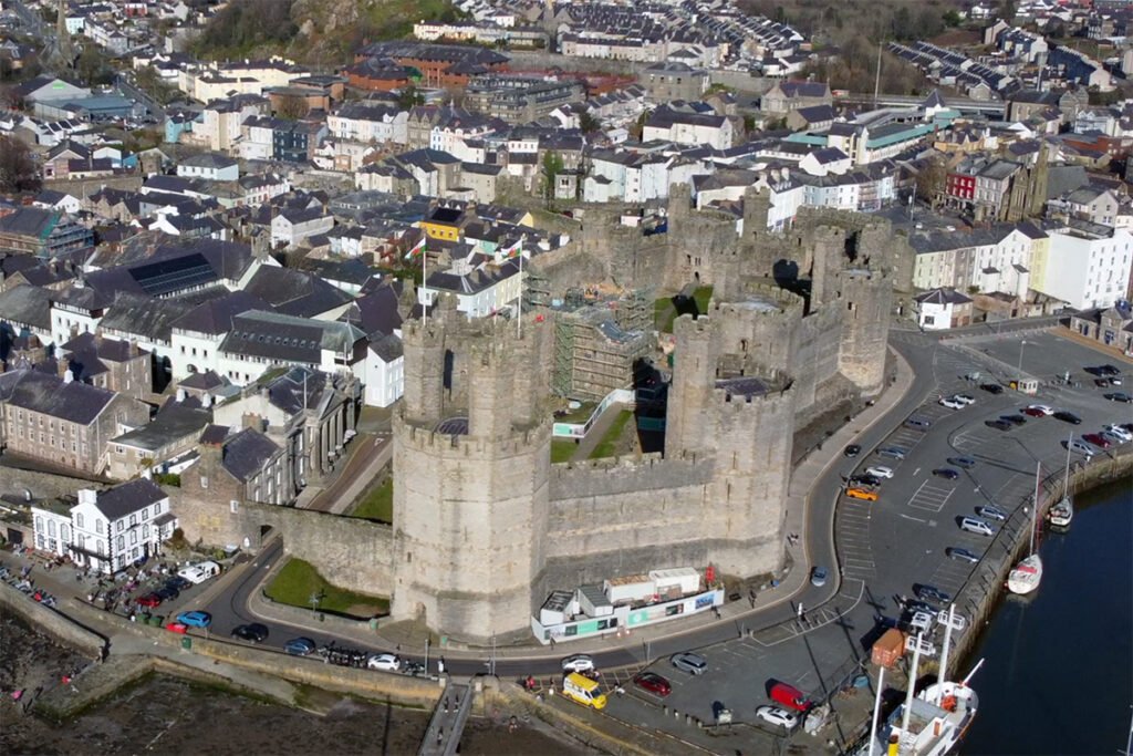 Aerial view of Caernarfon Castle beside the harbor