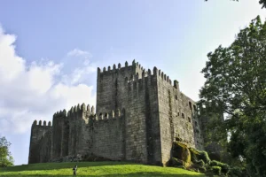 Castle of Guimaraes seen from grassy slope