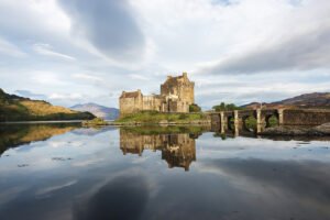 Eilean Donan Castle reflected in calm loch at sunrise