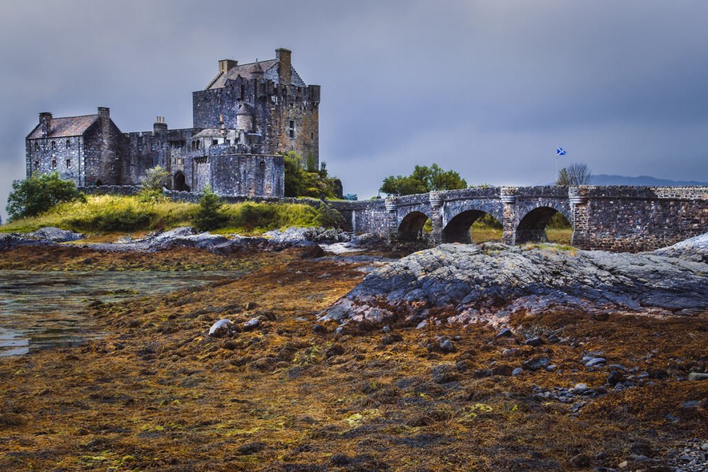 Eilean Donan Castle by stone bridge and shore