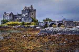 Eilean Donan Castle by stone bridge and shore