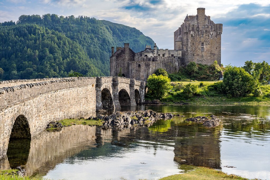 Eilean Donan Castle by stone bridge and loch