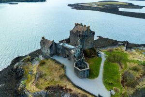 Aerial view of Eilean Donan Castle on rocky tidal island