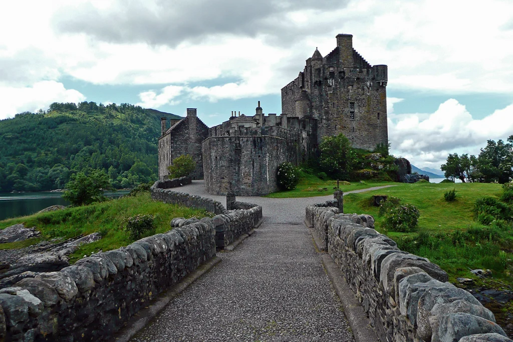 Eilean Donan Castle from stone bridge, loch and hills