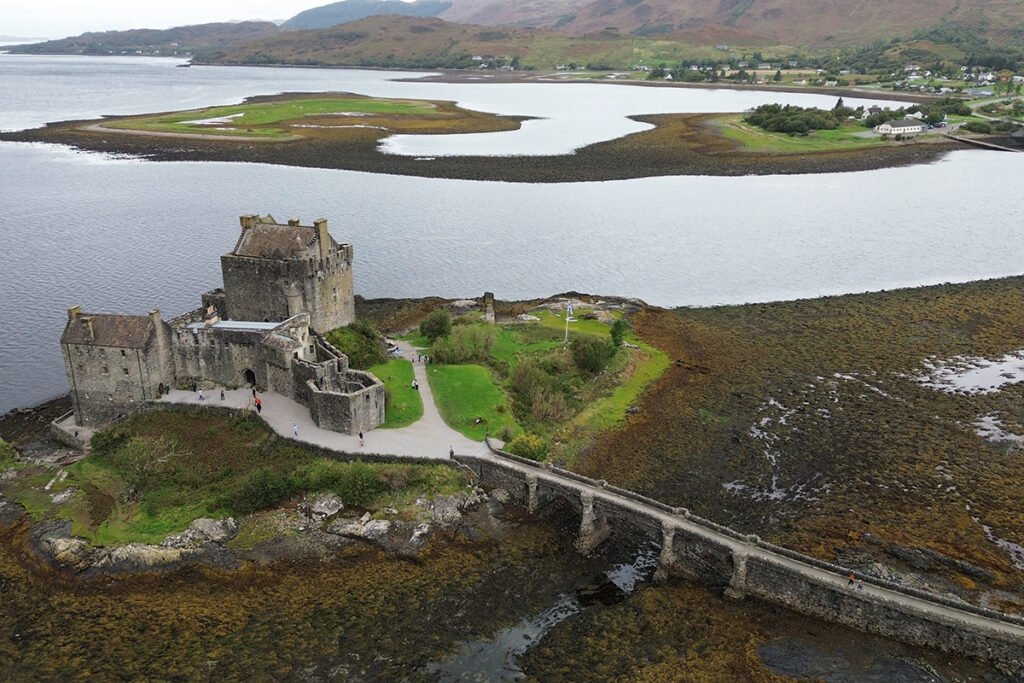 Aerial view of Eilean Donan Castle on rocky tidal island