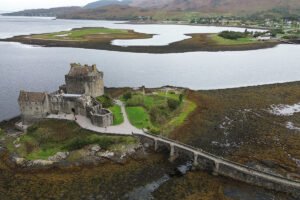 Aerial view of Eilean Donan Castle on rocky tidal island