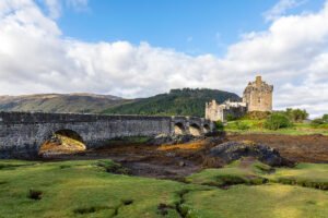 Eilean Donan Castle with stone bridge and tidal foreground