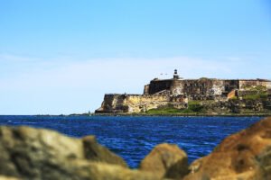 El Morro fortress on rocky coastline with lighthouse and blue sea