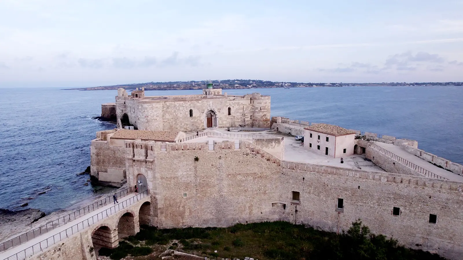 Aerial view of Maniace Castle on rocky seafront