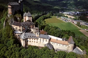 Aerial view of Orava Castle perched on rocky cliff