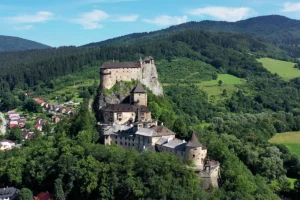 Orava Castle perched on rocky hill, surrounded by forested valley
