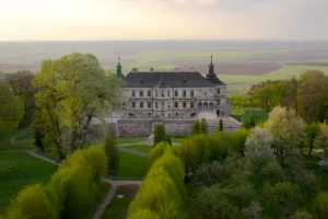 Aerial view of Pidhirtsi Castle surrounded by spring trees and rolling fields