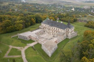 Aerial view of Pidhirtsi Castle with courtyard and surrounding autumn woodland