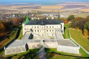 Aerial view of Pidhirtsi Castle overlooking fields and autumn trees