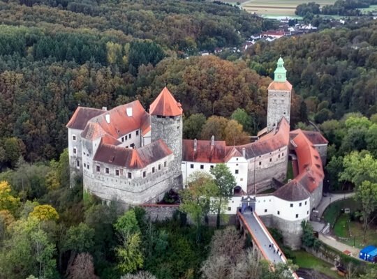 Aerial view of Schlaining Castle on wooded hill