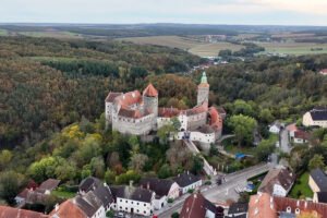 Aerial view of Schlaining Castle on wooded hilltop