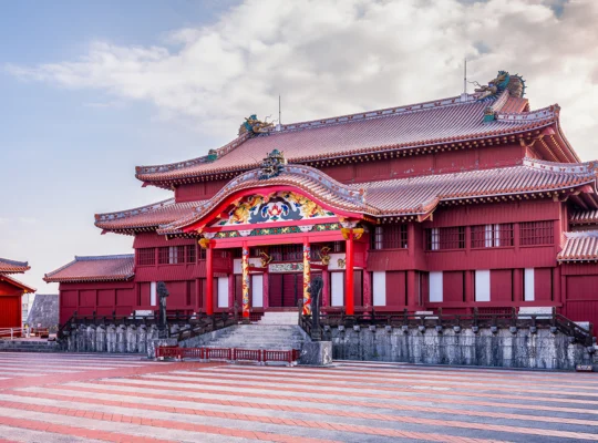 Shurijo Castle red main hall under pastel sky, wide courtyard