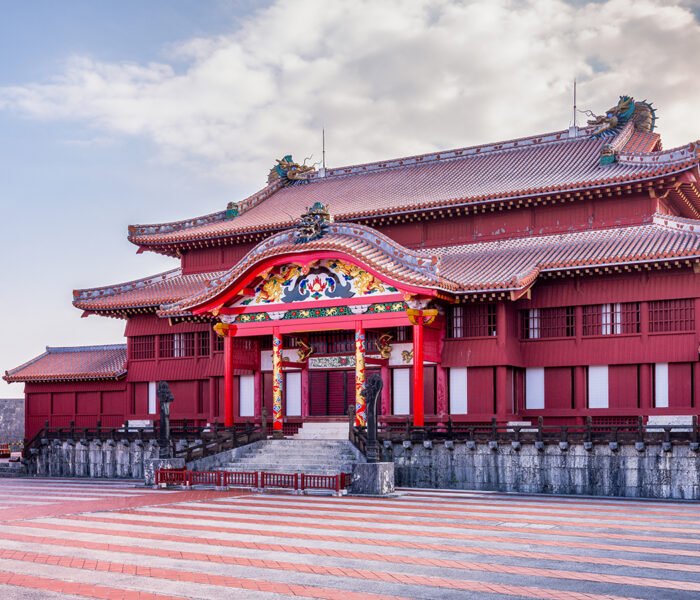 Shurijo Castle red main hall under pastel sky, wide courtyard