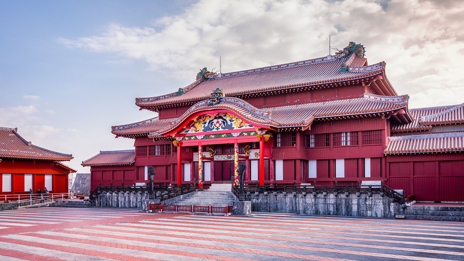 Shurijo Castle red main hall under pastel sky, wide courtyard
