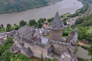 Aerial view of Stahleck Castle above river Rhine and town