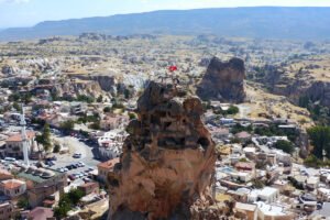 Aerial view of Uçhisar Castle rock fortress overlooking Cappadocia village