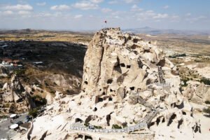 Aerial view of Uçhisar Castle carved rock fortress overlooking Cappadocia valleys