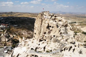 Aerial view of Uçhisar Castle carved rock fortress overlooking Cappadocia valleys