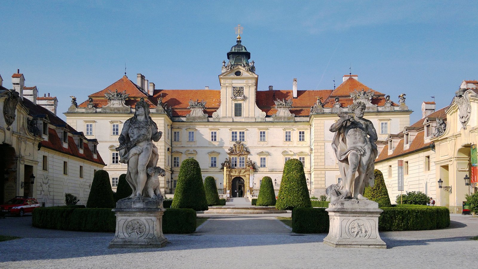 Front facade of Valtice Castle with statues and formal garden