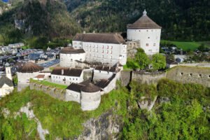 Aerial view of Kufstein Fortress perched on rocky cliff above town