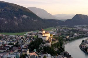 Aerial view of Kufstein Fortress on a rocky hill above river and town