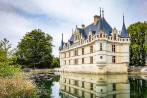 Azay‑le‑Rideau castle mirrored in calm moat under cloudy sky